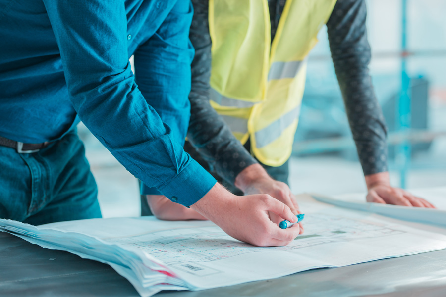 workers-checking-out-architectural-plan-project